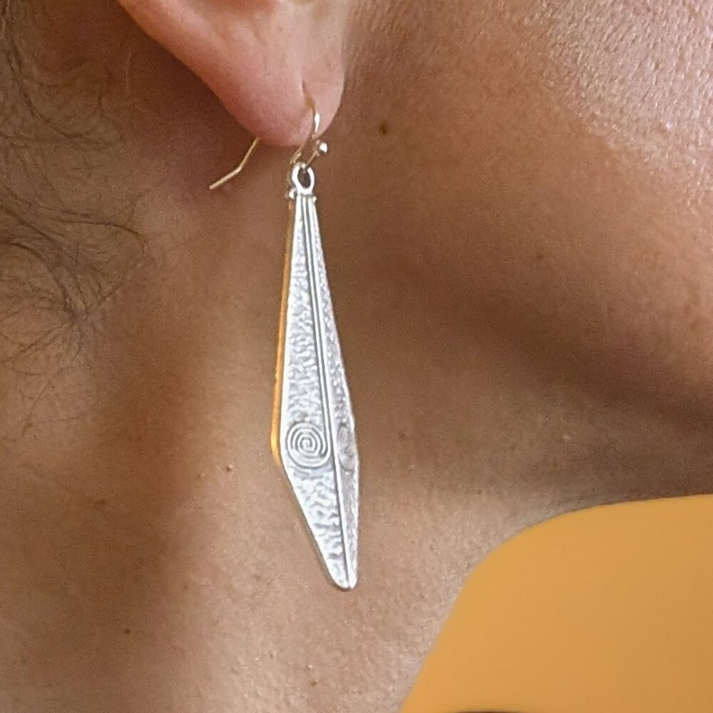 Beautiful drop silver earrings w/ a double swirl design.Silver-plated.